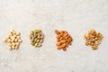 Four sorts of organic nuts: hazelnuts, pistachios, almonds, walnuts. Flat lay, top wives, copy space.