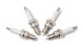 Four spark plugs on white. Top view. Royalty Free Stock Photo