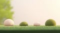 Four spherical objects of varying sizes and colors are arranged on a grassy surface. Royalty Free Stock Photo