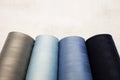 Four spools of cold colors: gray, blue and light blue. Sewing production and home crafts Royalty Free Stock Photo