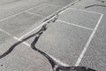 Four square lines on black asphalt with cracks