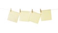 Four square notes papers hanging from miniature clothespins isolated with clipping path Royalty Free Stock Photo