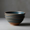 Four stacked ceramic bowls with a rustic finish, featuring a blend of brown and deep Royalty Free Stock Photo