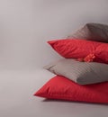 Four stacked cushions with red flower against the white background