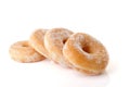 Four stacked sugared donuts over white background