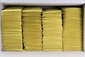 Four stacks of yellow mailing envelopes in a shipping box