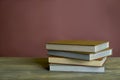 Four stamp albums books bunch on wooden table and bordeaux background Royalty Free Stock Photo