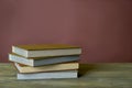 Four stamp albums books bunch on wooden table and bordeaux background. Royalty Free Stock Photo