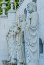 Four standing Buddha statues in front wall Royalty Free Stock Photo