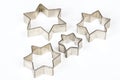 Four star shaped Christmas cookie cutters over white Royalty Free Stock Photo