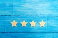 Four stars on a blue background. The concept of rating and evaluation. The rating of the hotel, restaurant, mobile application. Qu Royalty Free Stock Photo