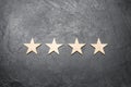 four stars on a dark background. The concept of rating