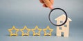Four stars and a wooden house on a gray background. Success. Feedback. Good evaluation of the critic. Hotel rating. Quality of