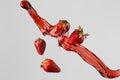 four strawberries and red juice splash Royalty Free Stock Photo