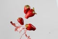 Four strawberries and red juice splash Royalty Free Stock Photo
