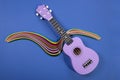 Four string ukulele guitar with a figure from colored paper