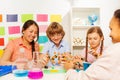 Four students studying chemistry at the classroom Royalty Free Stock Photo