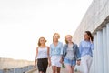 Four students walking down walkway Royalty Free Stock Photo