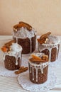 Four stylish homemade traditional Orthodox Easter delicious cakes on the white napkins decorated by dried bananas, orange apricots