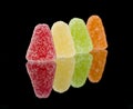 Four sugar coated sweets in a row