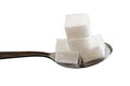 Four sugar cubes on a teaspoon