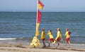 Four Surf Rescue Girls Patrolling and Flag