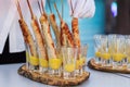 Four tasty grilled pork sausages from a BBQ served with a mustard dip on an old wooden cutting board in a close up view Royalty Free Stock Photo