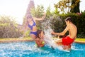 Two teen couples splash and play in water pool Royalty Free Stock Photo