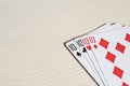 four ten poker hands playing cards on a light desk background. Royalty Free Stock Photo