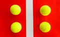 Four tennis balls divided by a field line Royalty Free Stock Photo