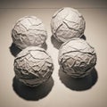 Four textured craft spheres arranged in a square pattern with distinct shadows Royalty Free Stock Photo