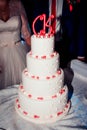 Four tiered wedding cake with white mastic and red beads Royalty Free Stock Photo