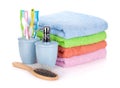 Four toothbrushes, liquid soap, hairbrush and colorful towels Royalty Free Stock Photo