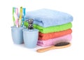 Four toothbrushes, liquid soap, hairbrush and colorful towels Royalty Free Stock Photo