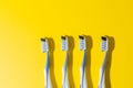 four toothbrushes on a yellow background. Royalty Free Stock Photo