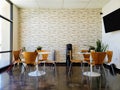 Four-top tables and plants in modern salon waiting area Royalty Free Stock Photo