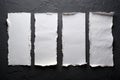 Four sheets of white torn paper on black wall Royalty Free Stock Photo
