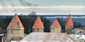 Four towers of a city wall, powdered with snow. Royalty Free Stock Photo