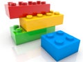 Four toy blocks of different sizes and colors on white Royalty Free Stock Photo