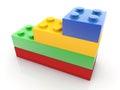 Four toy bricks of different sizes stacked on top of each other in different colors Royalty Free Stock Photo