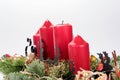 Four traditional red advent candles with christmas decoration Royalty Free Stock Photo