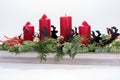 Four traditional red advent candles with christmas decoration Royalty Free Stock Photo