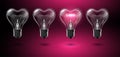 Four transparent heart-shaped bulbs, in one of which the word Love glows in place of a tungsten filament on a pink background.