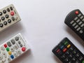 Four tv remotes in white background Royalty Free Stock Photo