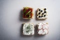 Four types of bruschetta on a kitchen table