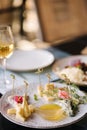 Four types of different cheeses sliced and served on a plate with honey sauce. Royalty Free Stock Photo