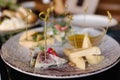 Four types of different cheeses sliced and served on a plate with honey sauce. Royalty Free Stock Photo