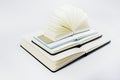 Four unfold notebooks lie on top of each other. Fan open notepad with blank light beige pages. White backdrop Royalty Free Stock Photo