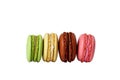 Four vertical macaroons. green, yellow, brown and pink macarons isolated on white. without a shadow