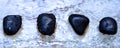 Four volcanic polished stones in zen composition Royalty Free Stock Photo